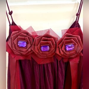 Unique and delicate flower appliqué baby doll dress.